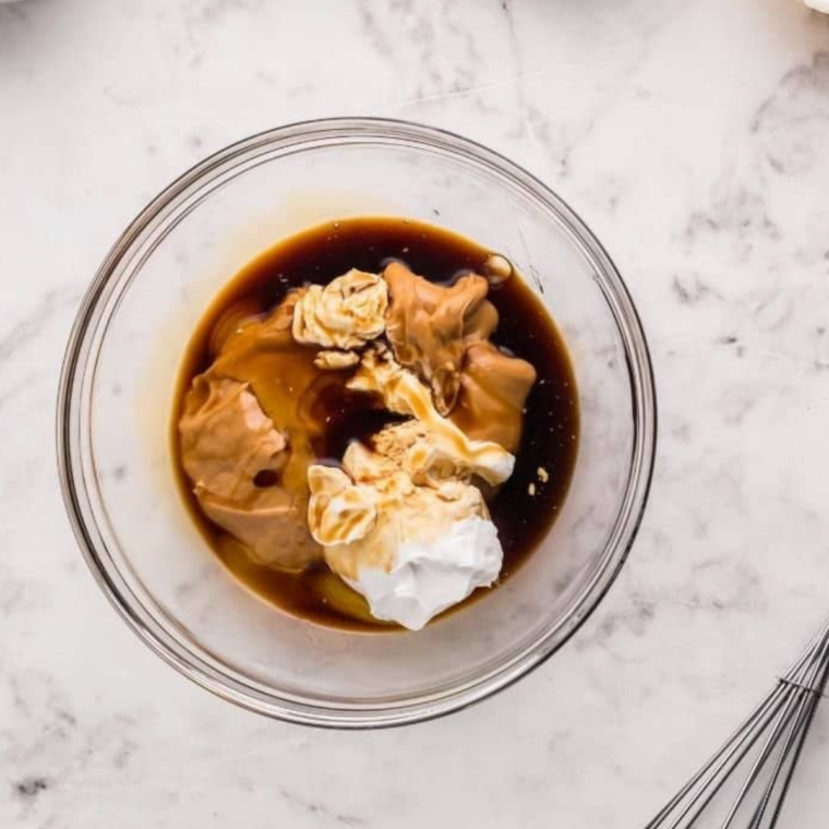 Making the peanut butter sauce in a large glass mixing bowl.