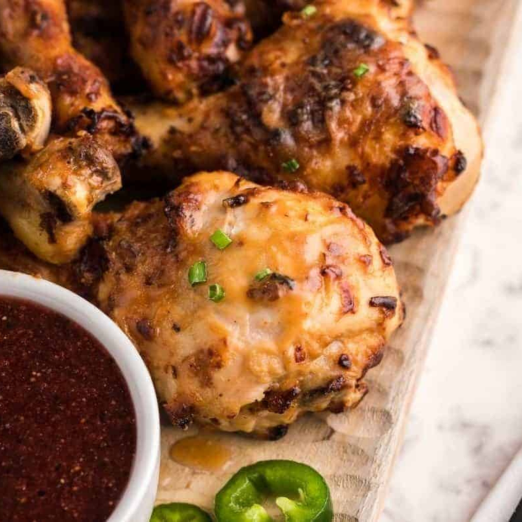 Close-up of juicy Air Fryer Peanut Butter Chicken with a creamy peanut sauce glaze.