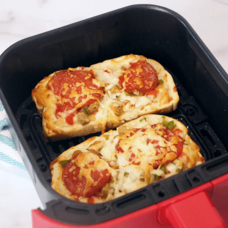 Air fryer set to 350&deg;F cooking pizza melts until cheese is melted and bread edges turn golden brown.