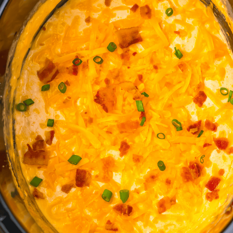 Whisking in beer, garlic powder, onion powder, Worcestershire sauce, and hot sauce into cream cheese mixture