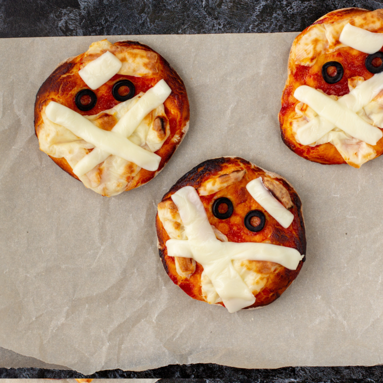 Air fryer mummy pizza made with melted cheese and crescent dough wrapped like a mummy