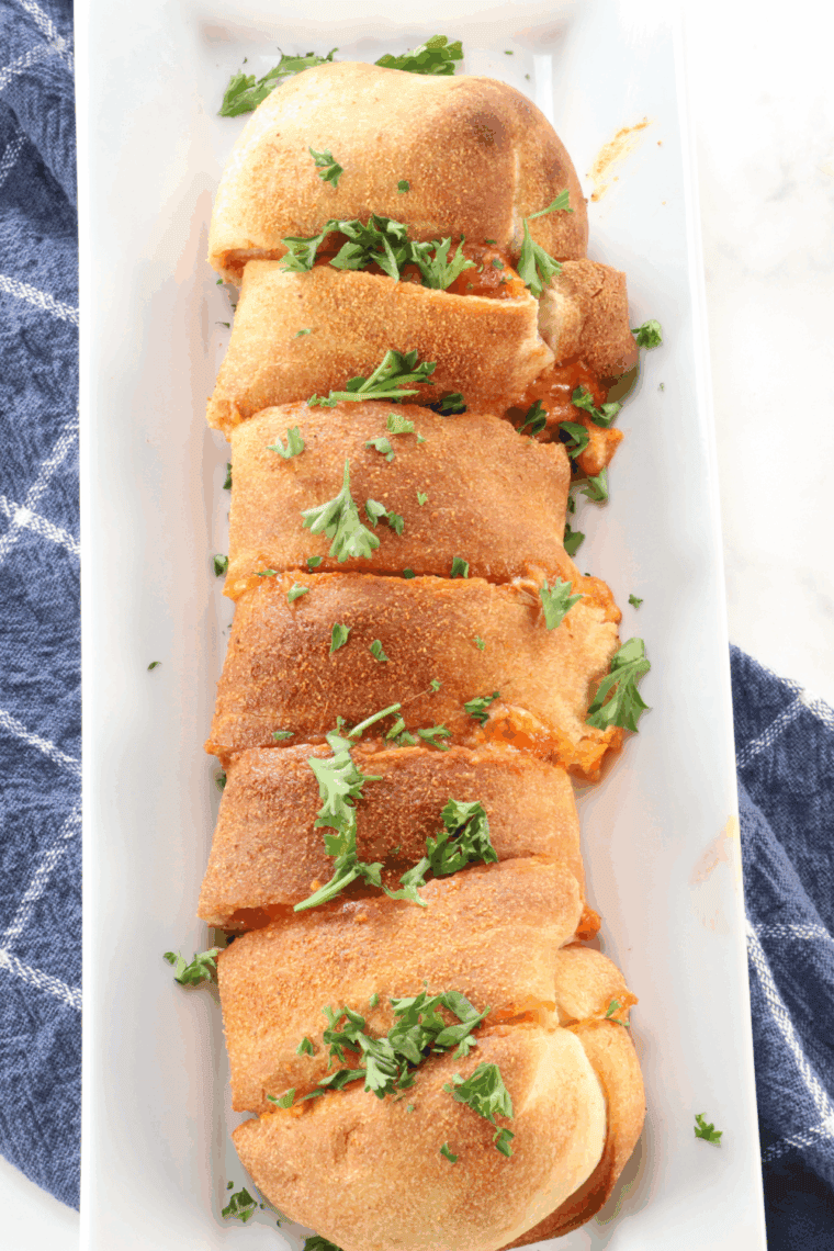 Air Fryer Pepperoni Stromboli sliced open, showing melted cheese and layers of pepperoni inside.