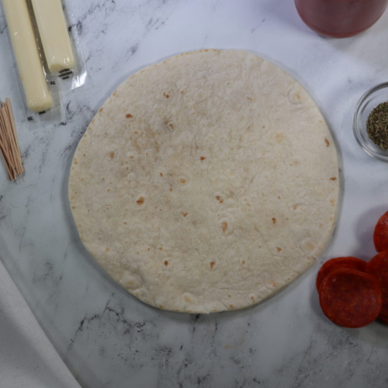 Ingredients for air fryer pizza sticks: pizza dough, cheese, pepperoni, and marinara sauce.