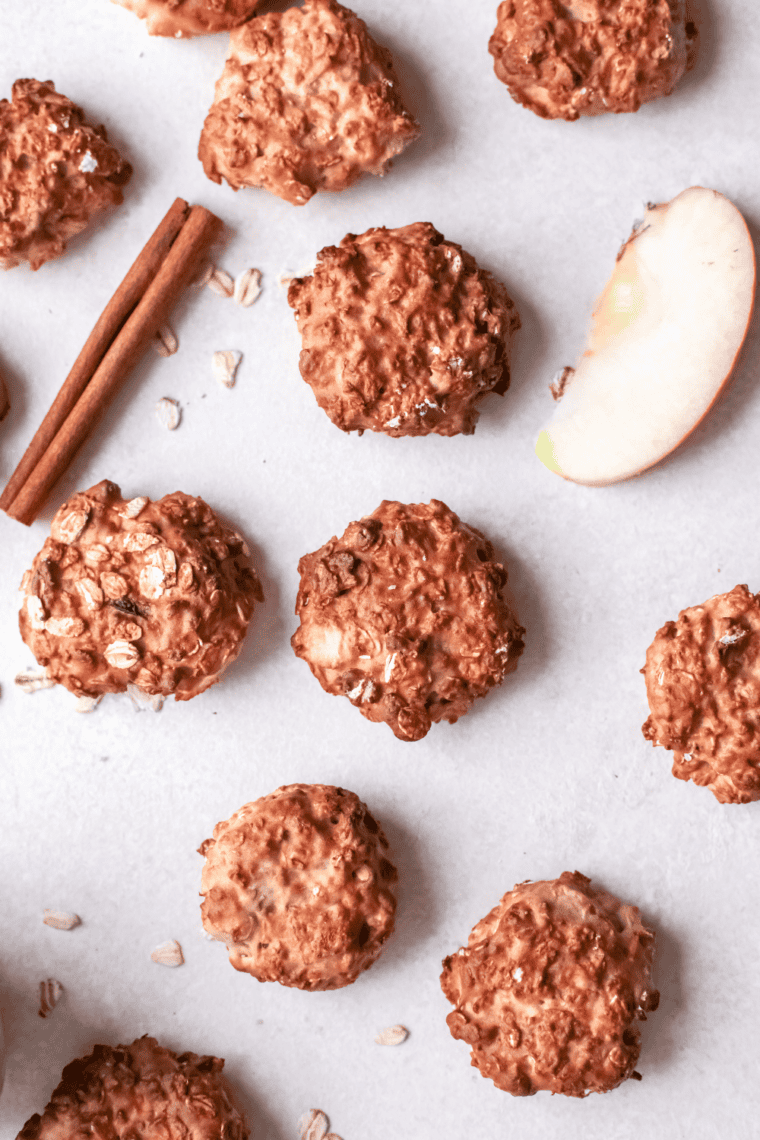 Air fryer apple breakfast cookies on a cooling rack, showing golden oats and spiced apple pieces