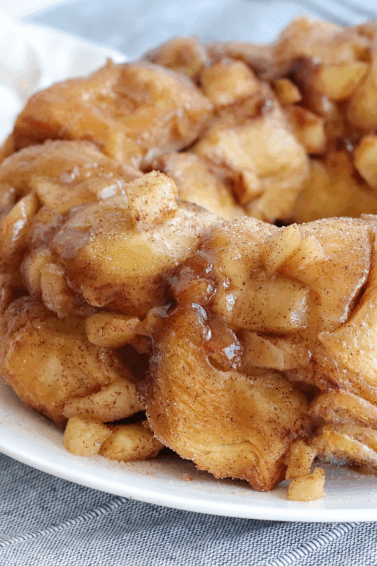 Golden, pull-apart apple cinnamon monkey bread fresh from the air fryer, drizzled with sweet glaze and topped with cinnamon sugar.