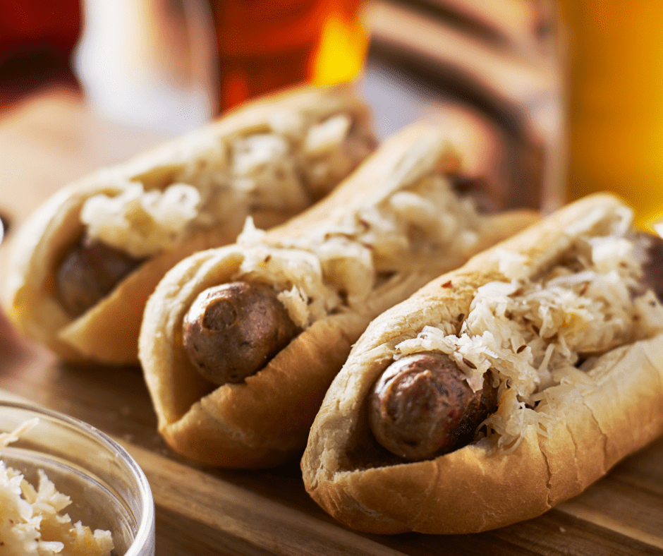 Close up of air fryer cheddar brats in buns with sauerkraut. 