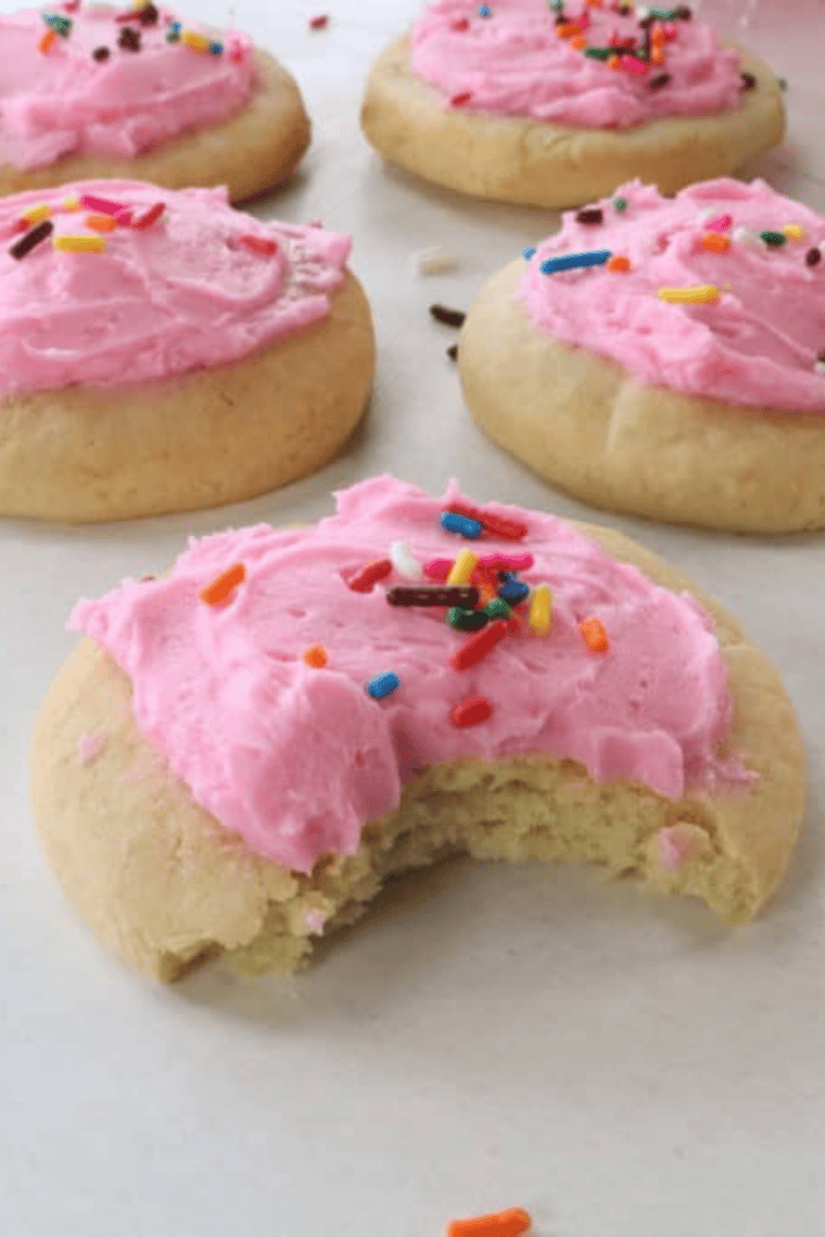 Plate of Air Fryer Copycat Lofthouse Cookies with pink frosting and colorful sprinkles