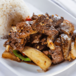 Golden air fryer cube steak with crispy edges and juicy center served on a plate with gravy.