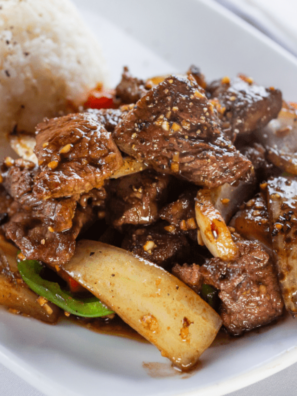 Golden air fryer cube steak with crispy edges and juicy center served on a plate with gravy.