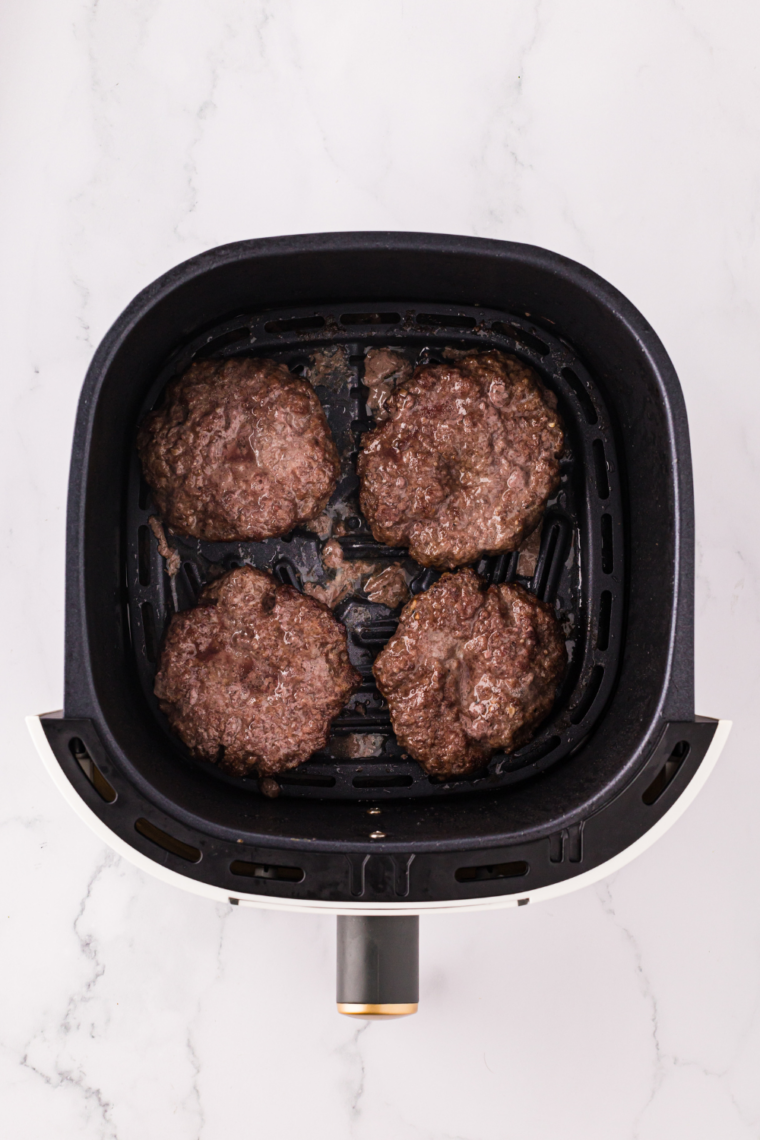 Cube steaks being coated in marinade inside a sealed bag and refrigerated to tenderize and enhance flavor.