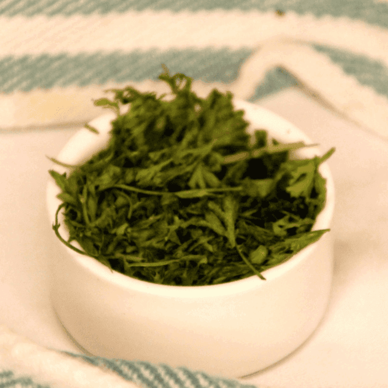 "Fresh parsley being dehydrated in the air fryer, ready for storage and future use."