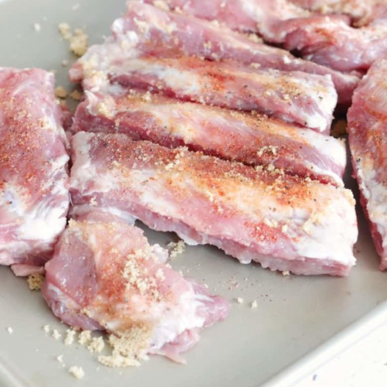 "Preparing ribs by scoring the membrane with large X-shaped cuts for tender, fall-off-the-bone texture."