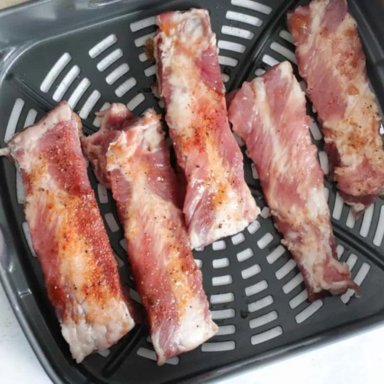 "Ribs seasoned with brown sugar, cumin, smoked paprika, garlic powder, salt, and black pepper for a flavorful coating."