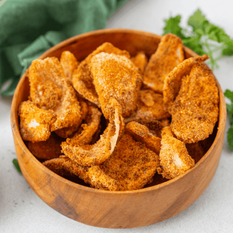 Cooked air fryer onion petals stored in an airtight glass container