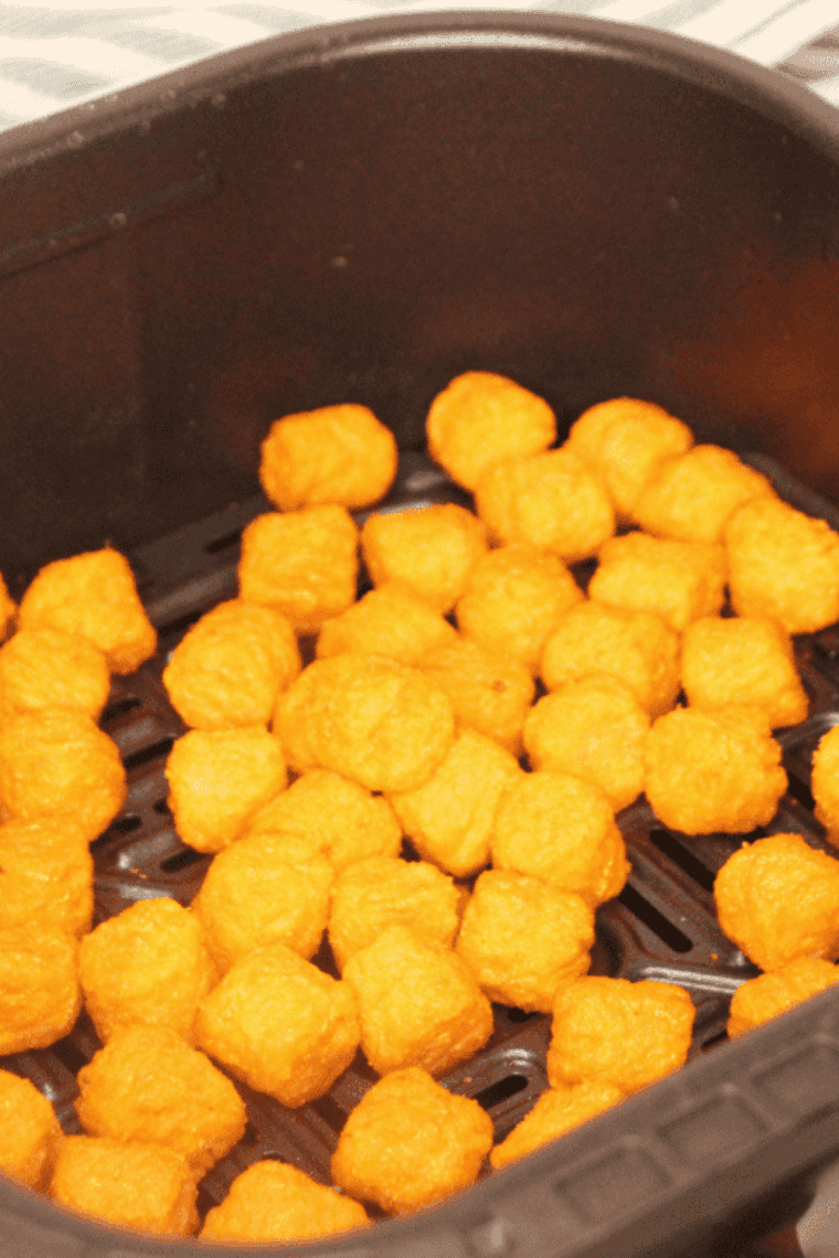 Golden and crispy Air Fryer Frozen Sweet Potato Tots served on a plate.