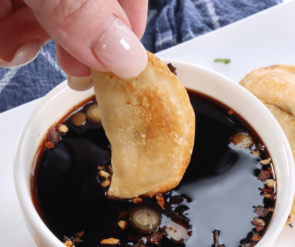 Air Fryer Pot stickers being dipped in sauce