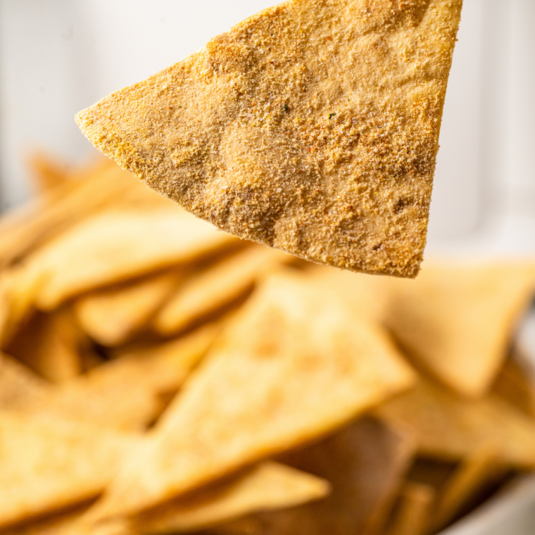 Finished air fryer taco tortilla chips cooling before serving with dip