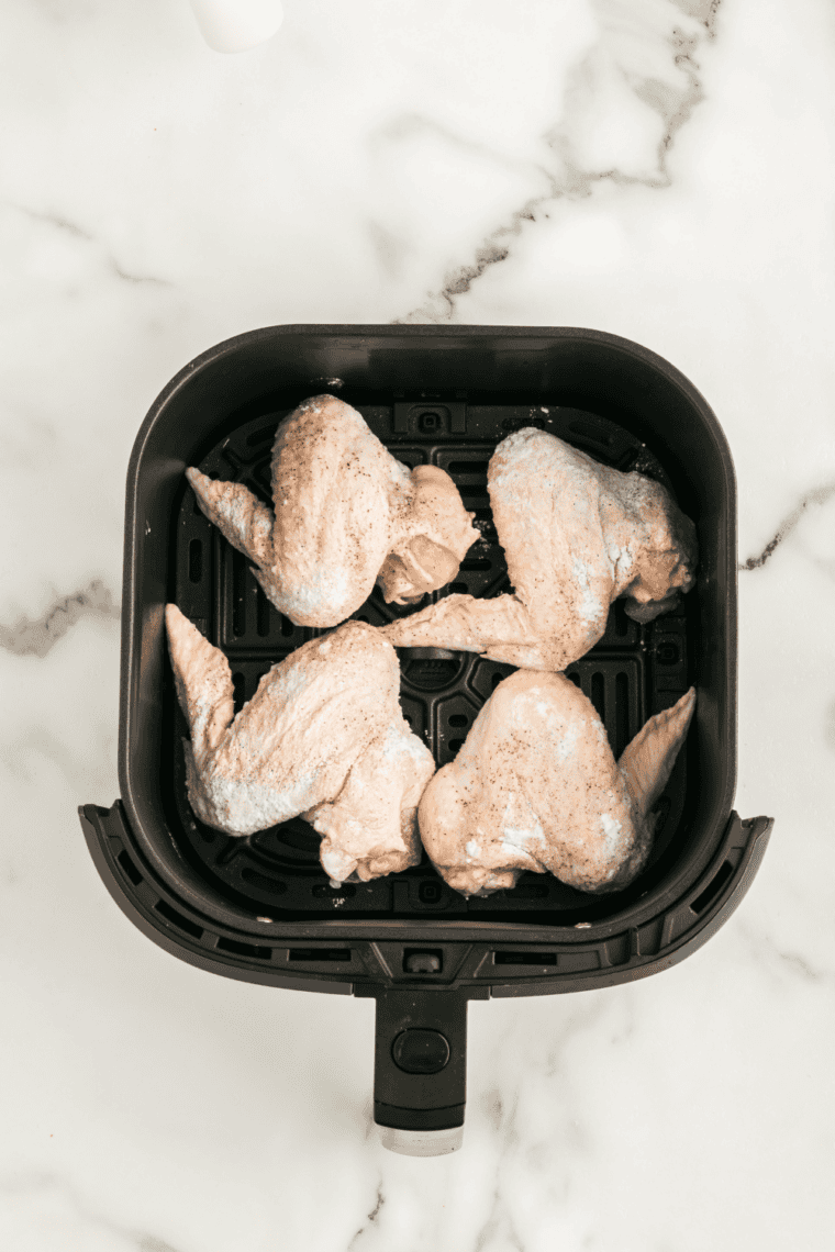 Chicken wings cooking until golden and crispy in air fryer or oven