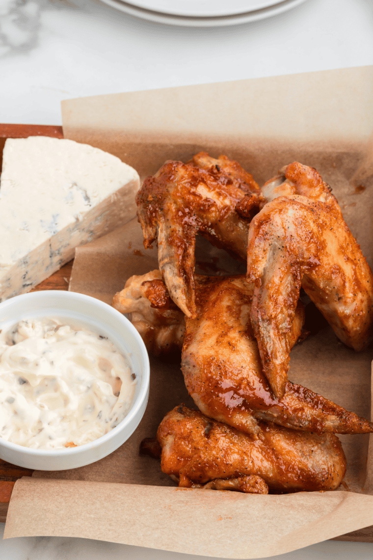 Serving mild chicken wings on a plate with dipping sauce