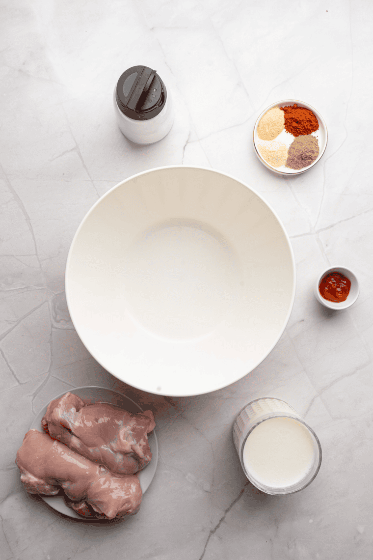 Ingredients needed for Wingstop Chicken Sandwich Ingredients on kitchen table.