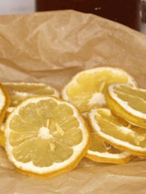 Air fryer dehydrated lemon slices arranged on a cooling rack, bright yellow citrus chips drying evenly.