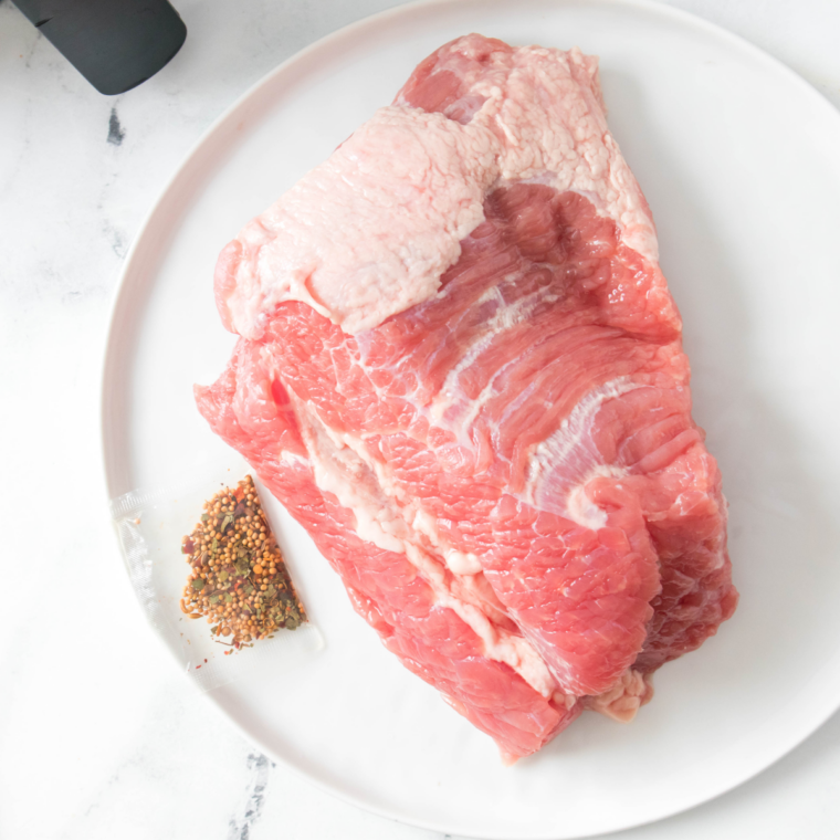 Rinsing corned beef brisket under cold water and drying with paper towels before applying mustard glaze.