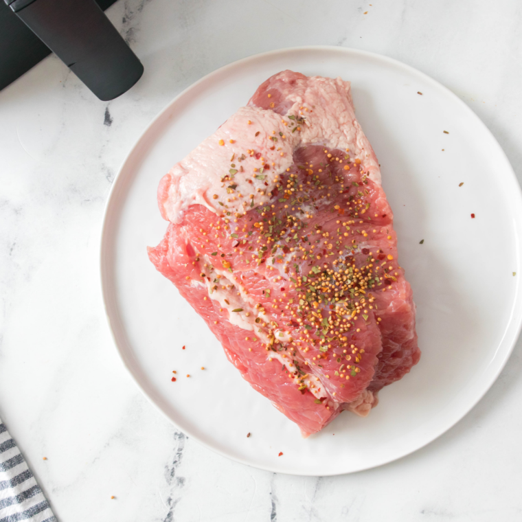 Mixing mustard, apple cider vinegar, and honey in a bowl to create a tangy glaze for corned beef brisket.