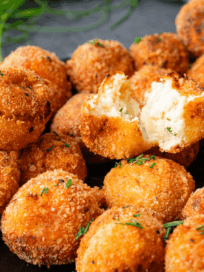 Crispy golden Cheesecake Factory Loaded Baked Potato Tots topped with melted cheese, bacon bits, and green onions