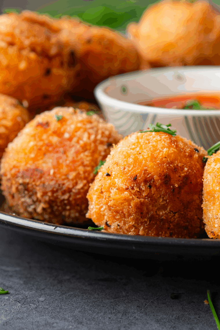 Golden, crispy loaded baked potato tots topped with melted cheese, bacon bits, and chopped green onions