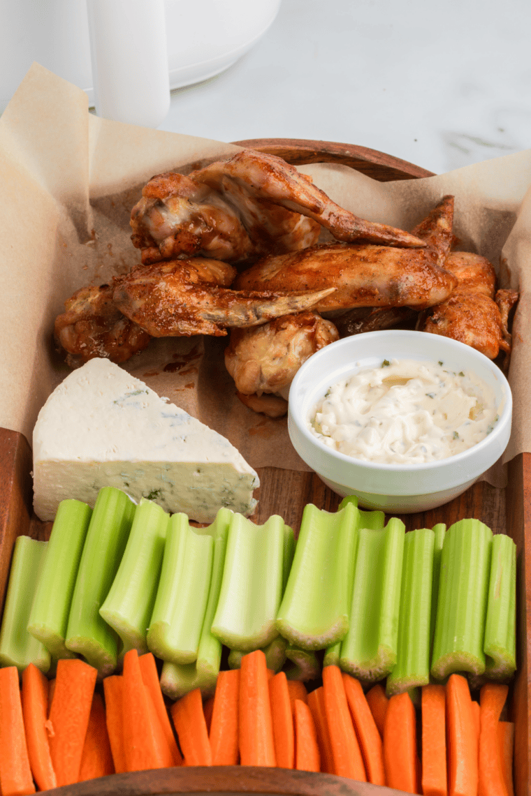 Crispy Hickory Smoked BBQ chicken wings coated in smoky sweet sauce on a plate, ready to serve.