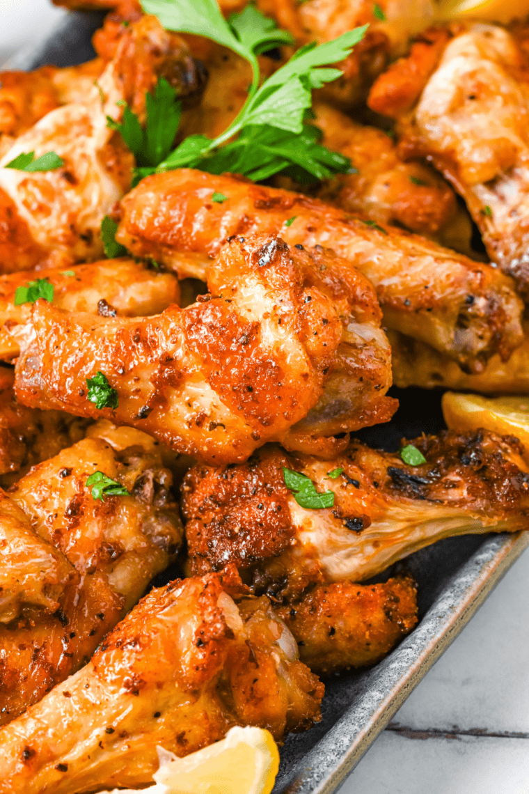 Crispy Wingstop Hot Honey Rub chicken wings coated in sweet and spicy sauce served on a plate.