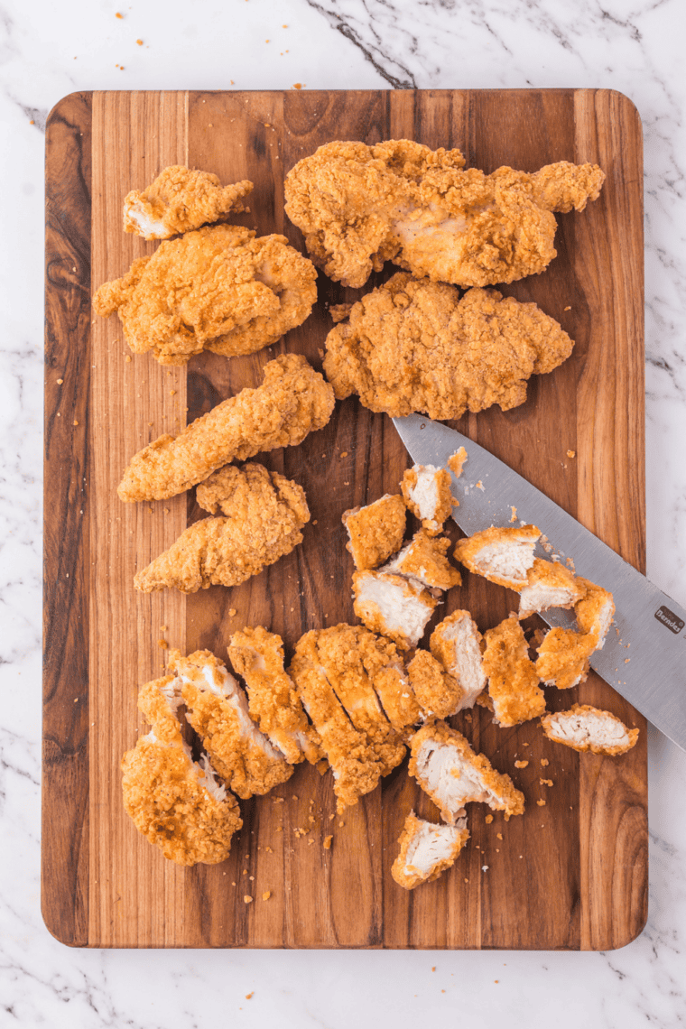 Crispy chicken strips resting after air frying to lock in crunch and heat.
