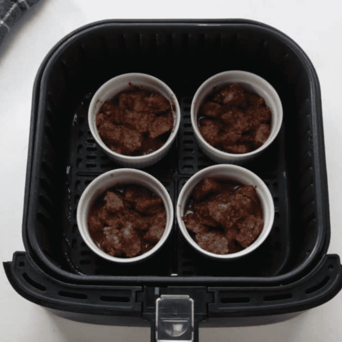 Place ramekins into the air fryer basket.