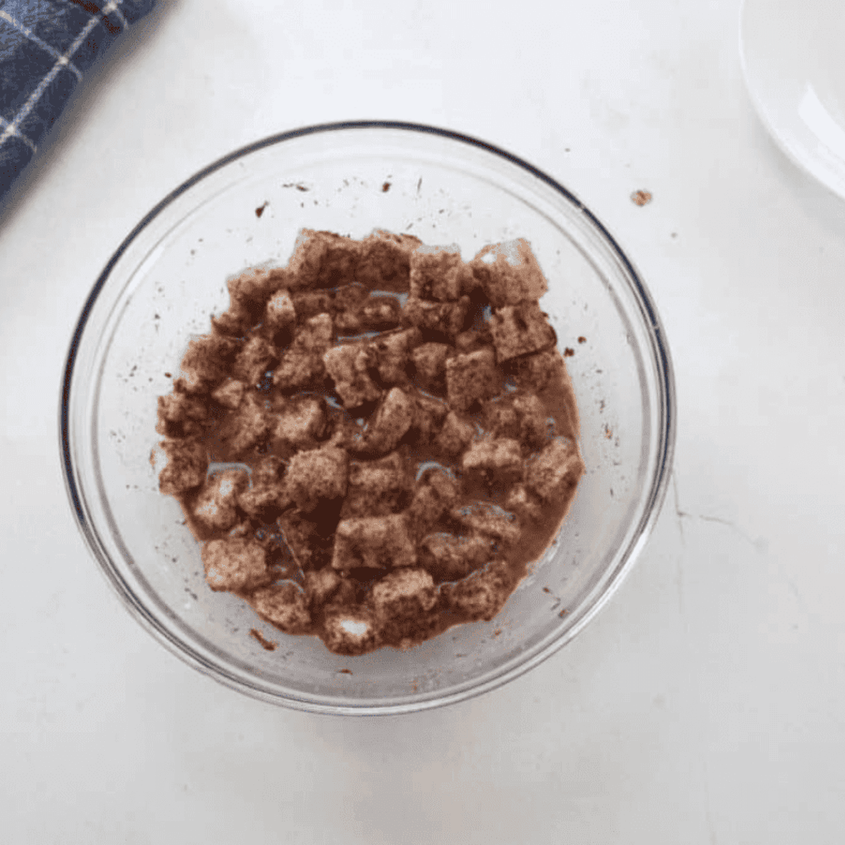 Adding bread cubes to the liquid mixture and letting them soak for 15–20 minutes.