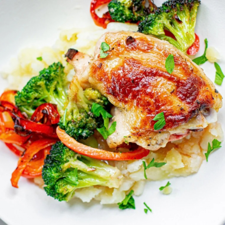 Crispy reheated chicken thighs resting on a plate, ready to serve
