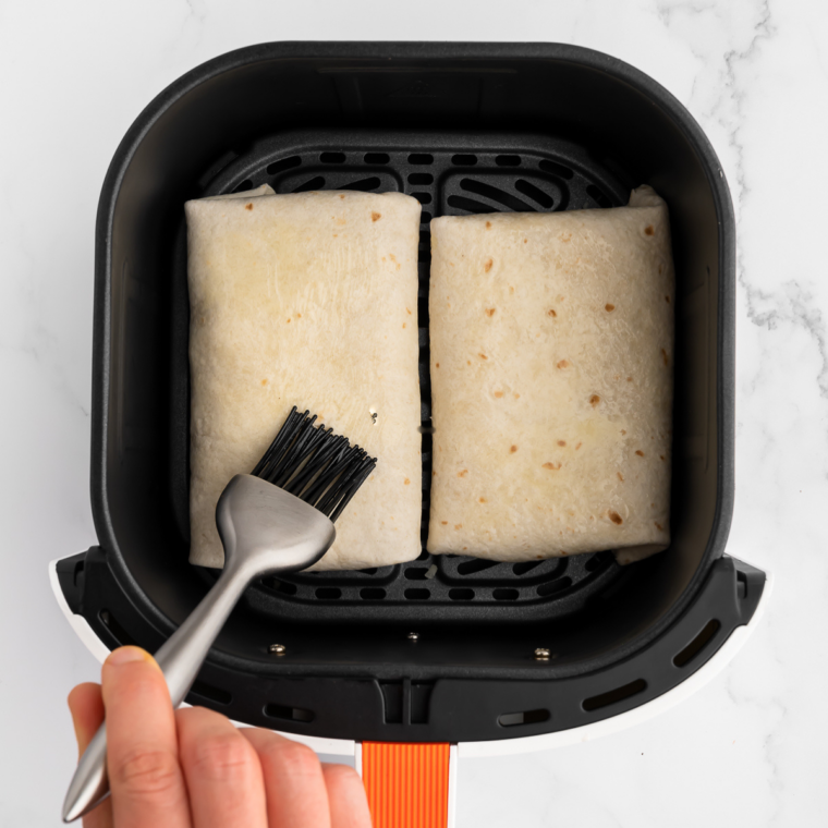 Stack of soft, warm tortillas on a plate, ready to serve.