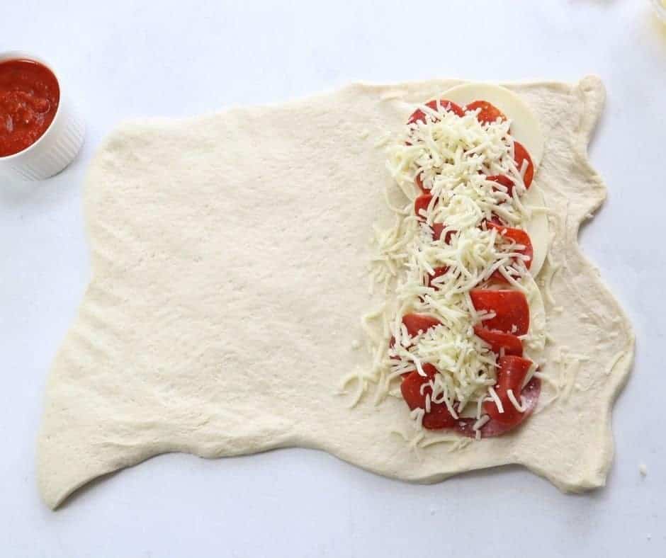adding ingredients for pepperoni stromboli
