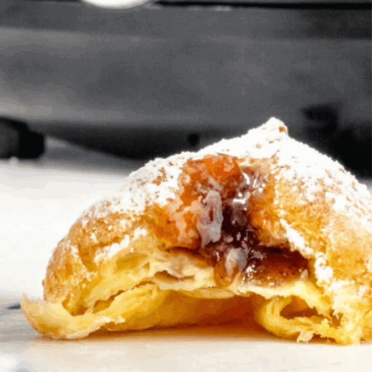 Air Fryer Sufganiyot – fluffy Israeli donuts filled with jelly and dusted with powdered sugar.