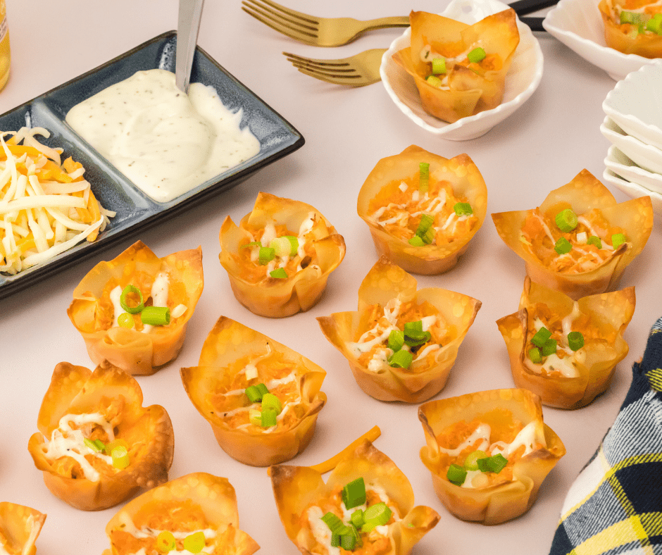  Looking for a quick and delicious party appetizer? Look no further than these Buffalo Chicken Wontons! Made with just a few simple ingredients and ready in under 20 minutes, these wontons are sure to be a hit at any gathering. Simply mix cooked chicken, cream cheese, hot sauce, cheddar cheese, and green onions together in a bowl and spoon into wonton wrappers. Bake in the oven until the wontons are crispy and serve with ranch or blue cheese dressing for dipping. These Buffalo Chicken Wontons are a crowd-pleasing appetizer that can be made in a snap! Give them a try at your next party or game day gathering. Your guests will be begging for the recipe!