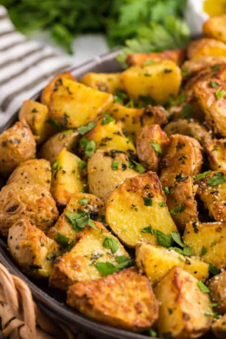 Air fryer cooking Air Fryer Greek Potatoes until crispy and golden brown.