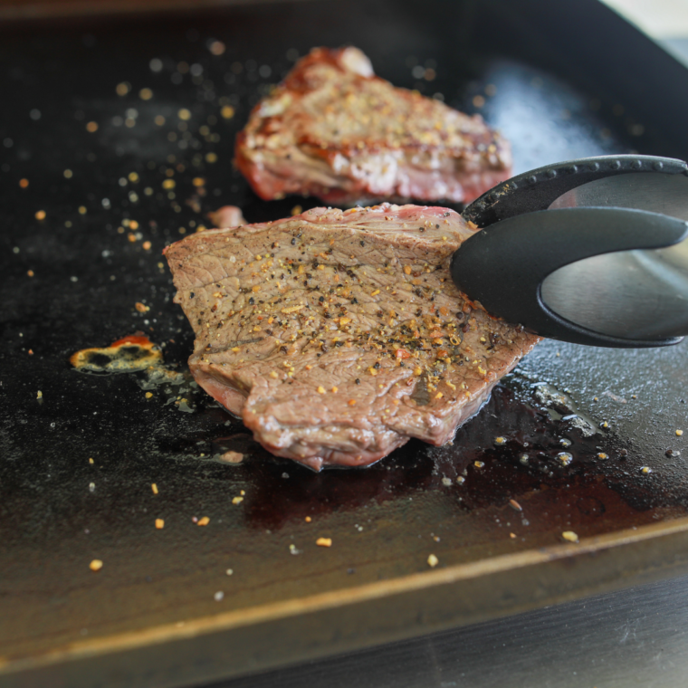 Cleaning a Blackstone griddle while preserving the seasoned cooking surface.