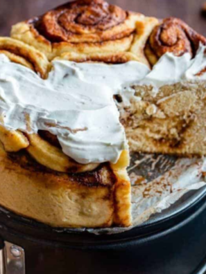Pioneer Woman cinnamon rolls in a round baking pan, topped with melting maple coffee frosting