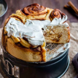 Pioneer Woman cinnamon rolls in a round baking pan, topped with melting maple coffee frosting