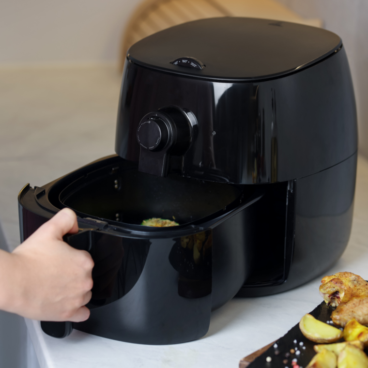 Safe air fryer setup on kitchen counter away from cabinets and walls