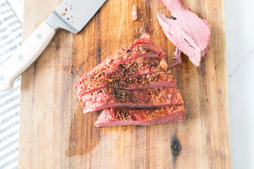 sliced corned beef brisket on cutting board