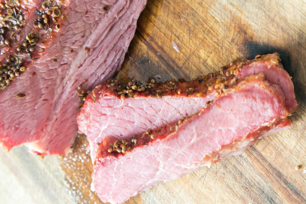 overhead of corned beef slices on cutting board