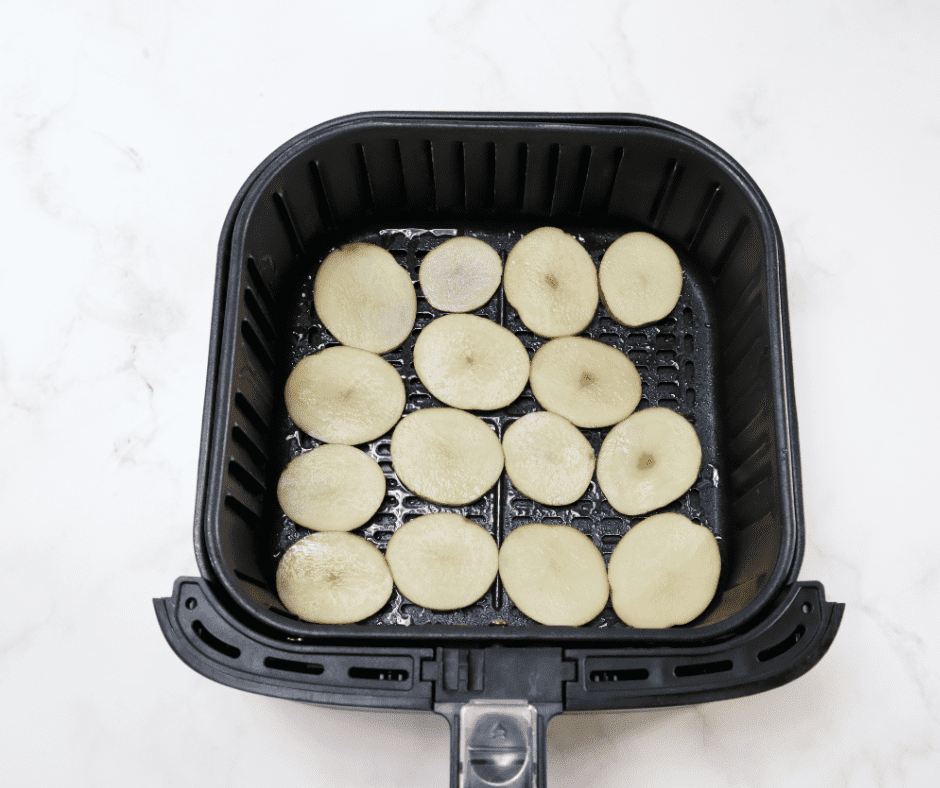 How To Make Sliced Potatoes In Air Fryer In the air fryer basket coated with olive oil.