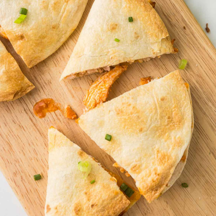 Golden crispy Blackstone chicken quesadilla griddling until the cheese melts.