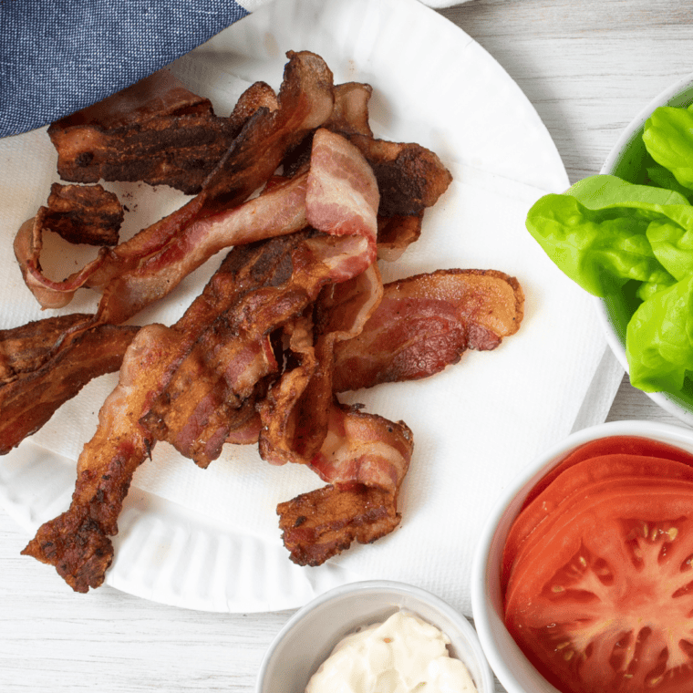 Perfectly crispy bacon cooking on the Blackstone griddle.