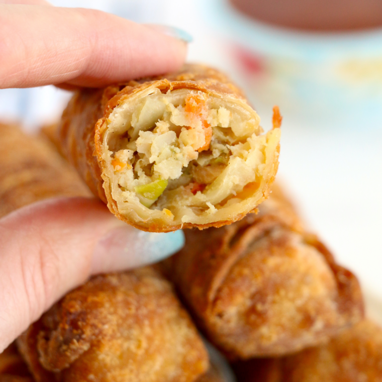 Crispy air fryer Pagoda egg roll being dipped into dipping sauce